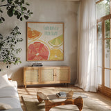 Citrus Splash I by Veronique Charron. Shown in a natural wood frame in a cozy modern living room. Available as an archival giclee rolled canvas, fine art paper, or poster print. SKU 37553a.