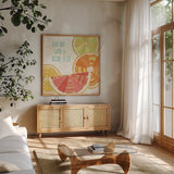 Citrus Splash II by Veronique Charron. Shown in a natural wood frame in a cozy modern living room. Available as an archival giclee rolled canvas, fine art paper, or poster print. SKU 37554a.