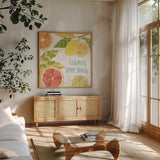 Citrus Splash III by Veronique Charron. Shown in a natural wood frame in a cozy modern living room. Available as an archival giclee rolled canvas, fine art paper, or poster print. SKU 37555a.