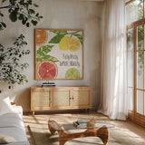 Citrus Splash III Black Text by Veronique Charron. Shown in a natural wood frame in a cozy modern living room. Available as an archival giclee rolled canvas, fine art paper, or poster print. SKU 56939a.