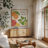 Citrus Splash IV Black Text by Veronique Charron. Shown in a natural wood frame in a cozy modern living room. Available as an archival giclee rolled canvas, fine art paper, or poster print. SKU 56942a.