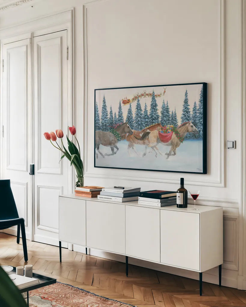 Christmas Mission by Wellington Studio. shown as a framed stretched canvas in a living room above a console. Available as a archival giclee rolled canvas, fine art paper, or poster print. SKU 100667i.