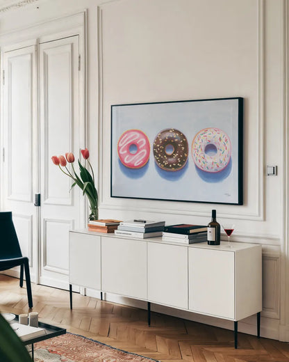 Doughnuts by Wellington Studio. shown as a framed stretched canvas in a living room above a console. Available as a archival giclee rolled canvas, fine art paper, or poster print. SKU 90650i.