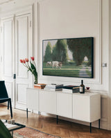 Grazing by Wellington Studio. shown as a framed stretched canvas in a living room above a console. Available as a archival giclee rolled canvas, fine art paper, or poster print. SKU 86908i.