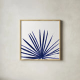 Statement Palms III Indigo by Wellington Studio. Shown in a natural wood glass frame for a timeless modern aesthetic. Available as an archival giclee rolled canvas, fine art paper, or poster print. SKU 34075a.