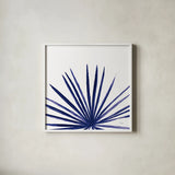 Statement Palms III Indigo by Wellington Studio. Shown in a crisp white glass frame for a clean and minimalist style. Available as an archival giclee rolled canvas, fine art paper, or poster print. SKU 34075a.