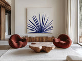 Statement Palms III Indigo by Wellington Studio. Shown as extra-large giant wall art in a modern living room. Available as an archival giclee rolled canvas, fine art paper, or poster print. SKU 34075a.