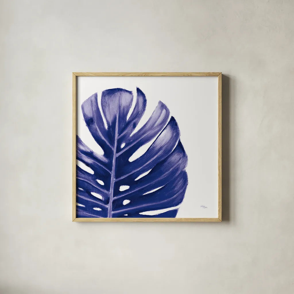 Statement Palms IV Indigo by Wellington Studio. Shown in a natural wood glass frame for a timeless modern aesthetic. Available as an archival giclee rolled canvas, fine art paper, or poster print. SKU 34076a.