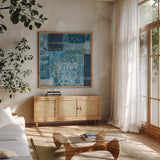 Alhambra III Indigo by Wild Apple Portfolio. Shown in a natural wood frame in a cozy modern living room. Available as an archival giclee rolled canvas, fine art paper, or poster print. SKU 16836a.