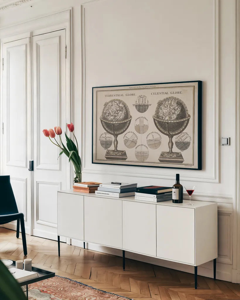 Antique Globes Neutral by Wild Apple Portfolio. shown as a framed stretched canvas in a living room above a console. Available as a archival giclee rolled canvas, fine art paper, or poster print. SKU 52845i.