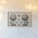 Antique Globes Neutral by Wild Apple Portfolio. shown as a paper print in a white frame. Available as a archival giclee rolled canvas, fine art paper, or poster print. SKU 52845i.