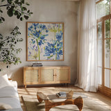 Blue Medley III by Wild Apple Portfolio. Shown in a natural wood frame in a cozy modern living room. Available as an archival giclee rolled canvas, fine art paper, or poster print. SKU 13258a.