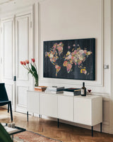 Botanical Floral Map by Wild Apple Portfolio. shown as a framed stretched canvas in a living room above a console. Available as a archival giclee rolled canvas, fine art paper, or poster print. SKU 53454i.