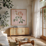 Botanical Pink Rose II You by Wild Apple Portfolio. Shown in a natural wood frame in a cozy modern living room. Available as an archival giclee rolled canvas, fine art paper, or poster print. SKU 53889a.