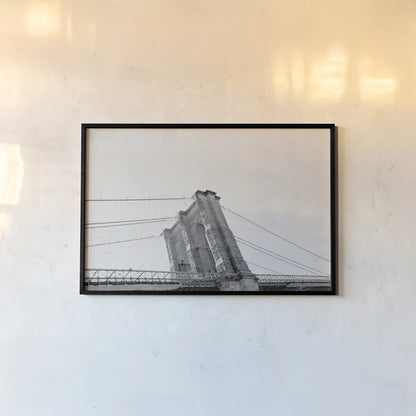 Brooklyn Bridge From Below by Wild Apple Portfolio. shown as a paper print in a black flame. Available as a archival giclee rolled canvas, fine art paper, or poster print. SKU 67630i.