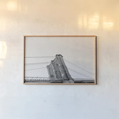 Brooklyn Bridge From Below by Wild Apple Portfolio. shown as a paper print in a natural frame. Available as a archival giclee rolled canvas, fine art paper, or poster print. SKU 67630i.