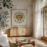 Butterfly Mandala I v2 by Wild Apple Portfolio. Shown in a natural wood frame in a cozy modern living room. Available as an archival giclee rolled canvas, fine art paper, or poster print. SKU 35994a.
