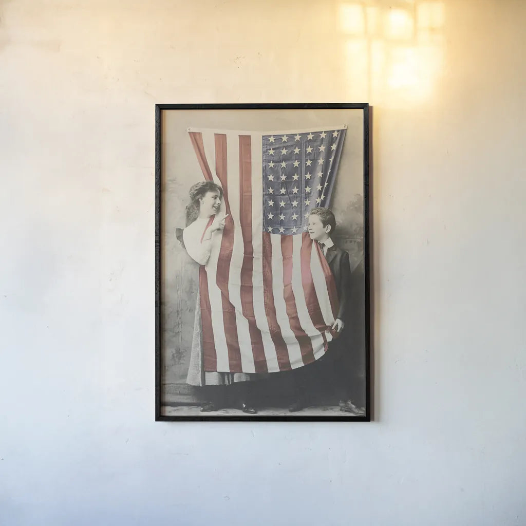 Children With American Flag by Wild Apple Portfolio. shown as a paper print in a black flame. Available as a archival giclee rolled canvas, fine art paper, or poster print. SKU 99050h.