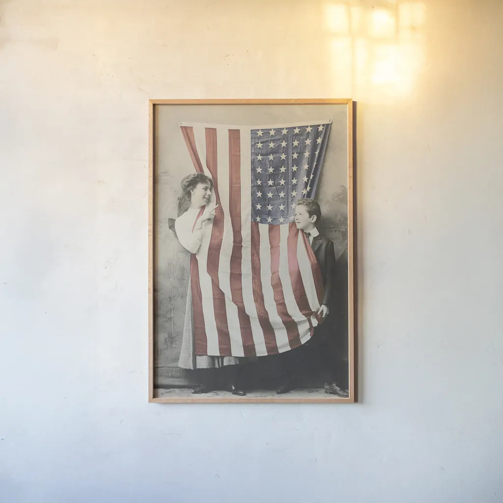 Children With American Flag by Wild Apple Portfolio. shown as a paper print in a natural frame. Available as a archival giclee rolled canvas, fine art paper, or poster print. SKU 99050h.
