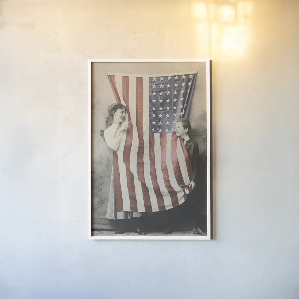 Children With American Flag by Wild Apple Portfolio. shown as a paper print in a white frame. Available as a archival giclee rolled canvas, fine art paper, or poster print. SKU 99050h.