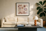 Circles Blush by Wild Apple Portfolio. Displayed in a glass frame with matte in a clean modern living room. Available as an archival giclee rolled canvas, fine art paper, or poster print. SKU 42735a.