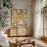 Endless Circles Front Gold II by Wild Apple Portfolio. Shown in a natural wood frame in a cozy modern living room. Available as an archival giclee rolled canvas, fine art paper, or poster print. SKU 32244a.