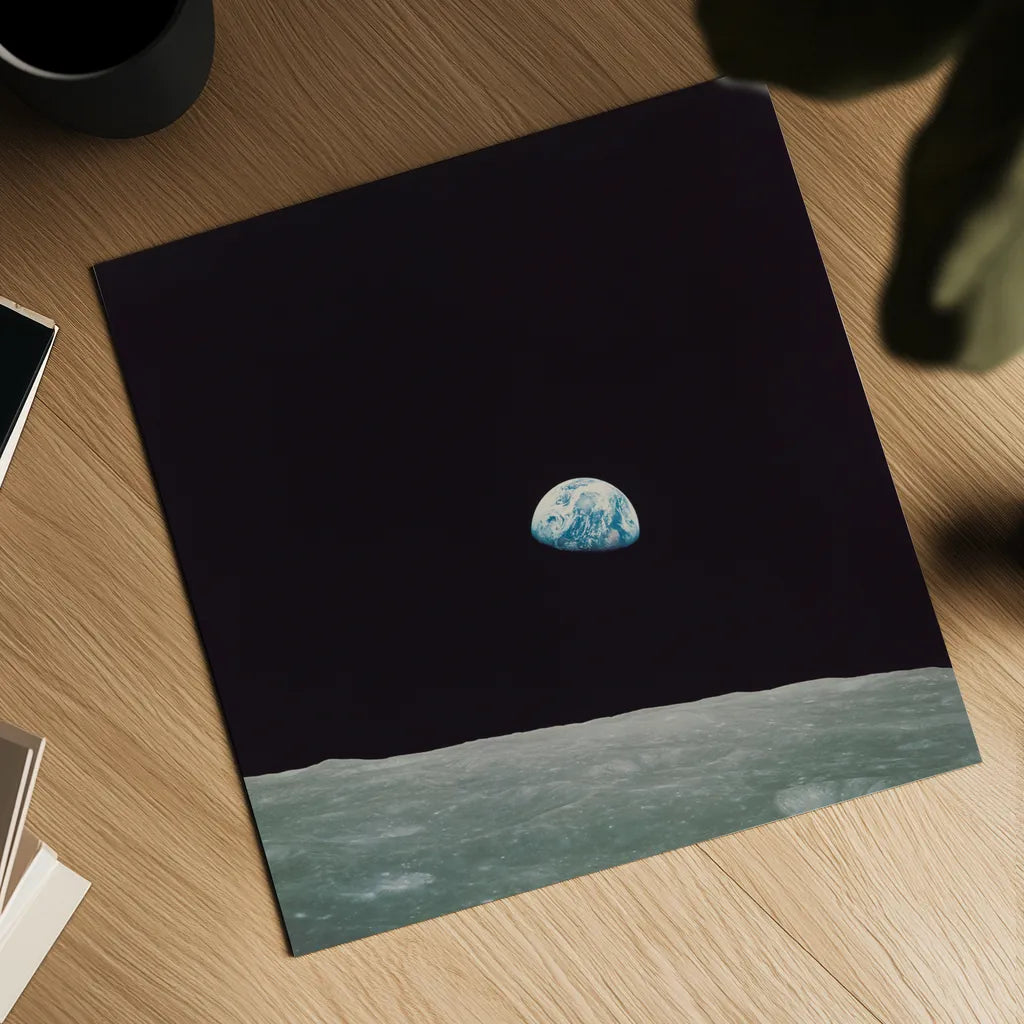 First Earth Rise by Wild Apple Portfolio. Shown as a detailed flat fine art print, highlighting archival giclee quality. Available as an archival giclee rolled canvas, fine art paper, or poster print. SKU 84536a.