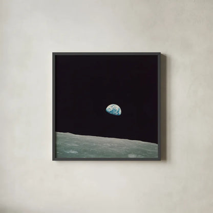 First Earth Rise by Wild Apple Portfolio. Shown in a sleek black glass frame for a contemporary gallery look. Available as an archival giclee rolled canvas, fine art paper, or poster print. SKU 84536a.