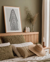 Flatiron Building NYC by Wild Apple Portfolio. shown as a paper print in a natural frame. Available as a archival giclee rolled canvas, fine art paper, or poster print. SKU 67632h.