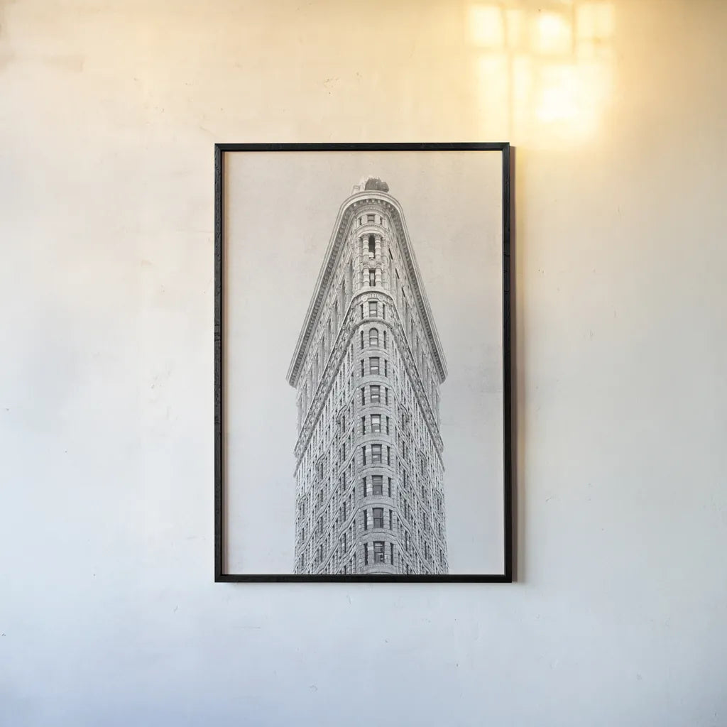 Flatiron Building NYC by Wild Apple Portfolio. shown as a paper print in a black flame. Available as a archival giclee rolled canvas, fine art paper, or poster print. SKU 67632h.