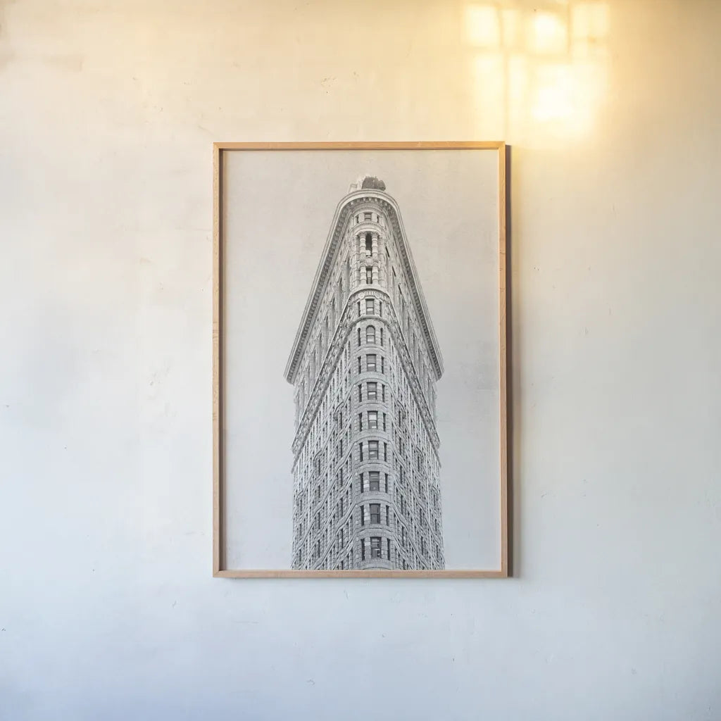 Flatiron Building NYC by Wild Apple Portfolio. shown as a paper print in a natural frame. Available as a archival giclee rolled canvas, fine art paper, or poster print. SKU 67632h.