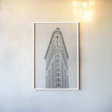 Flatiron Building NYC by Wild Apple Portfolio. shown as a paper print in a white frame. Available as a archival giclee rolled canvas, fine art paper, or poster print. SKU 67632h.