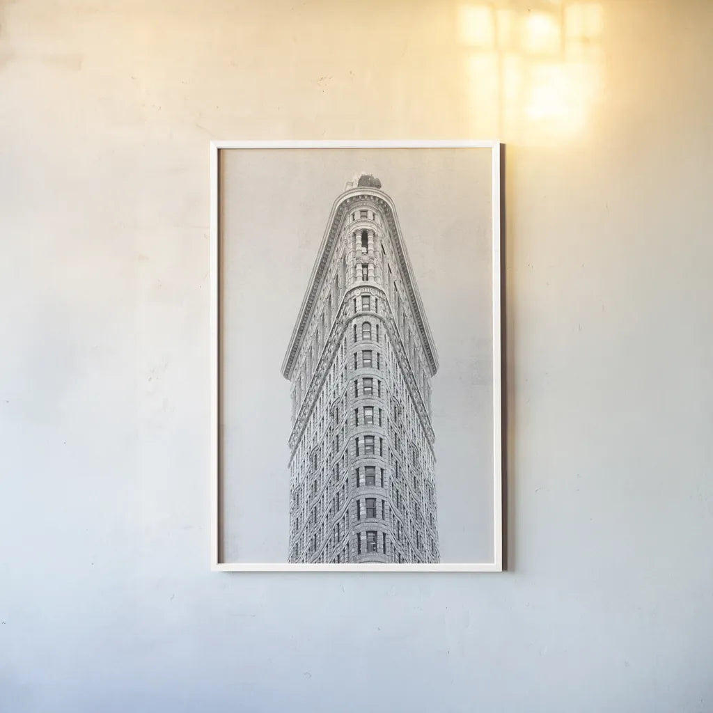 Flatiron Building NYC by Wild Apple Portfolio. shown as a paper print in a white frame. Available as a archival giclee rolled canvas, fine art paper, or poster print. SKU 67632h.