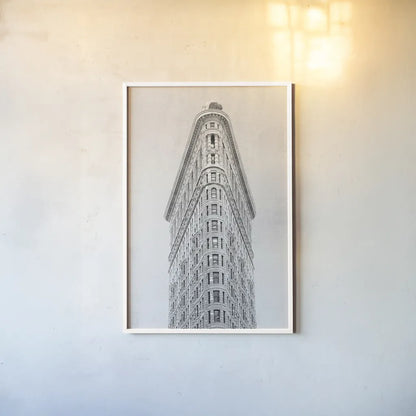 Flatiron Building NYC by Wild Apple Portfolio. shown as a paper print in a white frame. Available as a archival giclee rolled canvas, fine art paper, or poster print. SKU 67632h.