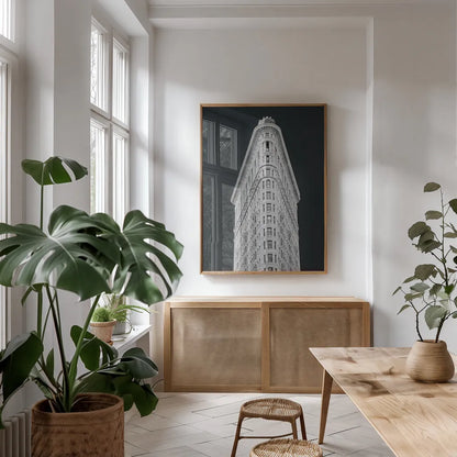 Flatiron Building on Black by Wild Apple Portfolio. shown as a print in a natural wood frame in a dining room. Available as a archival giclee rolled canvas, fine art paper, or poster print. SKU 68473h.