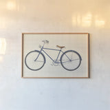 Flea Market Bicycle Navy by Wild Apple Portfolio. shown as a paper print in a natural frame. Available as a archival giclee rolled canvas, fine art paper, or poster print. SKU 74745i.