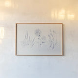 Flowers on White VIII Blue by Wild Apple Portfolio. shown as a paper print in a natural frame. Available as a archival giclee rolled canvas, fine art paper, or poster print. SKU 78211i.