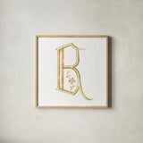 French Sewing Letter B by Wild Apple Portfolio. Shown in a natural wood glass frame for a timeless modern aesthetic. Available as an archival giclee rolled canvas, fine art paper, or poster print. SKU 43228a.