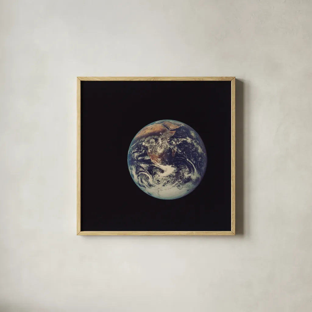Full Disk Earth by Wild Apple Portfolio. Shown in a natural wood glass frame for a timeless modern aesthetic. Available as an archival giclee rolled canvas, fine art paper, or poster print. SKU 84533a.