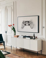 Garage Gaming by Wild Apple Portfolio. shown as a framed stretched canvas in a living room above a console. Available as a archival giclee rolled canvas, fine art paper, or poster print. SKU 73372i.