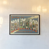 Greetings from Hollywood v2 by Wild Apple Portfolio. shown as a paper print in a black flame. Available as a archival giclee rolled canvas, fine art paper, or poster print. SKU 45240i.