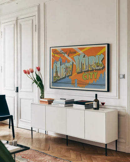 Greetings from New York by Wild Apple Portfolio. shown as a framed stretched canvas in a living room above a console. Available as a archival giclee rolled canvas, fine art paper, or poster print. SKU 45242i.