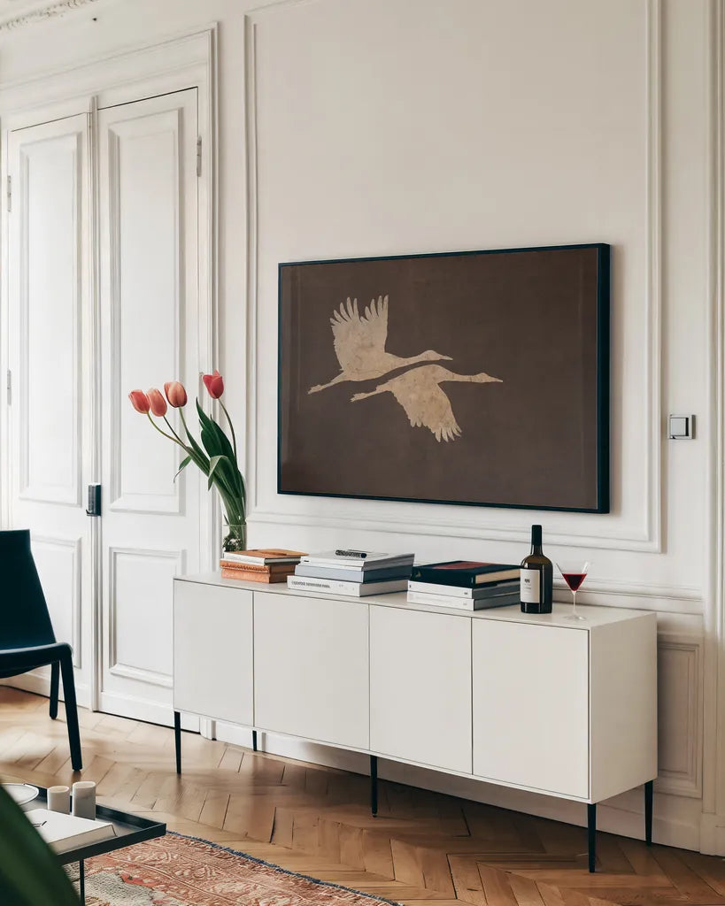 Herons in Flight Mocha by Wild Apple Portfolio. shown as a framed stretched canvas in a living room above a console. Available as a archival giclee rolled canvas, fine art paper, or poster print. SKU 96471i.