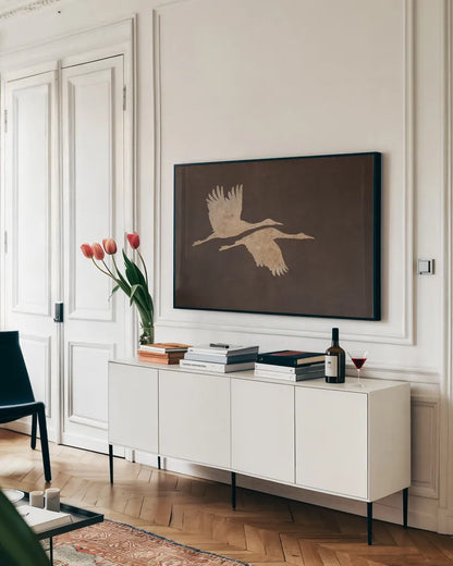 Herons in Flight Mocha by Wild Apple Portfolio. shown as a framed stretched canvas in a living room above a console. Available as a archival giclee rolled canvas, fine art paper, or poster print. SKU 96471i.