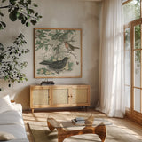 Honeybloom Bird V by Wild Apple Portfolio. Shown in a natural wood frame in a cozy modern living room. Available as an archival giclee rolled canvas, fine art paper, or poster print. SKU 89362a.