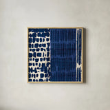 Indigo Batik I by Wild Apple Portfolio. Shown in a natural wood glass frame for a timeless modern aesthetic. Available as an archival giclee rolled canvas, fine art paper, or poster print. SKU 16448a.