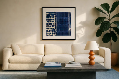 Indigo Batik I by Wild Apple Portfolio. Displayed in a glass frame with matte in a clean modern living room. Available as an archival giclee rolled canvas, fine art paper, or poster print. SKU 16448a.