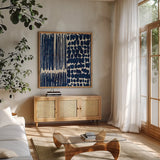 Indigo Batik III by Wild Apple Portfolio. Shown in a natural wood frame in a cozy modern living room. Available as an archival giclee rolled canvas, fine art paper, or poster print. SKU 16450a.