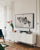 Lake Life Sign by Wild Apple Portfolio. shown as a framed stretched canvas in a living room above a console. Available as a archival giclee rolled canvas, fine art paper, or poster print. SKU 72462i.