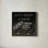 Lets Watch a Movie by Wild Apple Portfolio. Shown in a sleek black glass frame for a contemporary gallery look. Available as an archival giclee rolled canvas, fine art paper, or poster print. SKU 21553a.